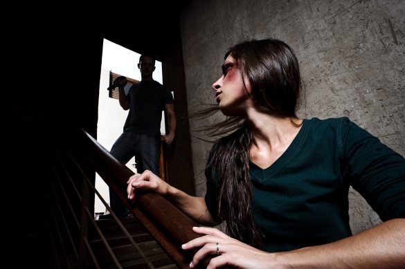 Concept of domestic abuse. Battered woman escaping from man silh